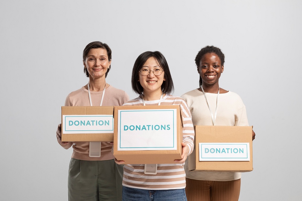 Charity people carrying donation boxes 1Kpx